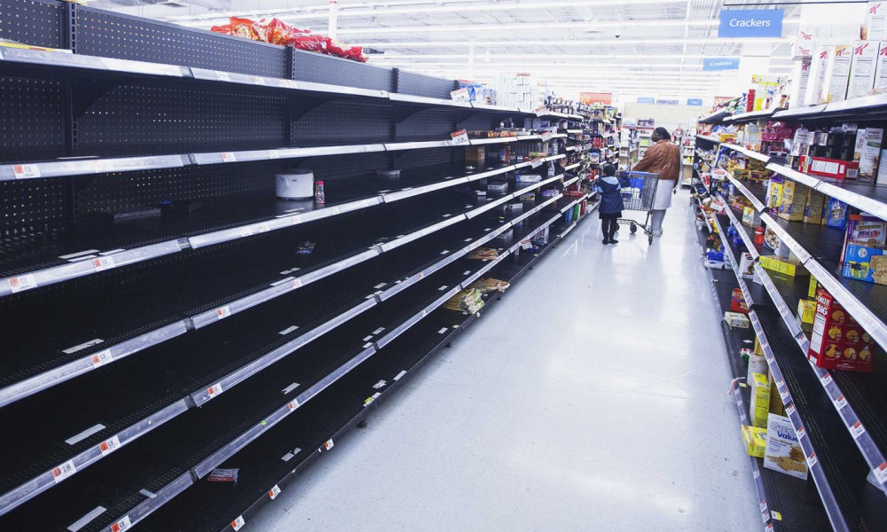 A woman and child walk through an aisle, emptied in preparation for Hurricane Sandy, in a Wal-Mart store in Riverhead, New York, October 28, 2012.  REUTERS/Lucas Jackson (UNITED STATES - Tags: ENVIRONMENT DISASTER BUSINESS TPX IMAGES OF THE DAY)