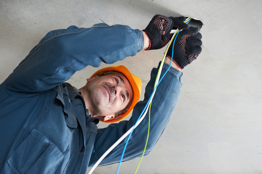 One electrician working with cable mounting and assembling new wiring